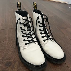 White lace up Dr Marten boots.